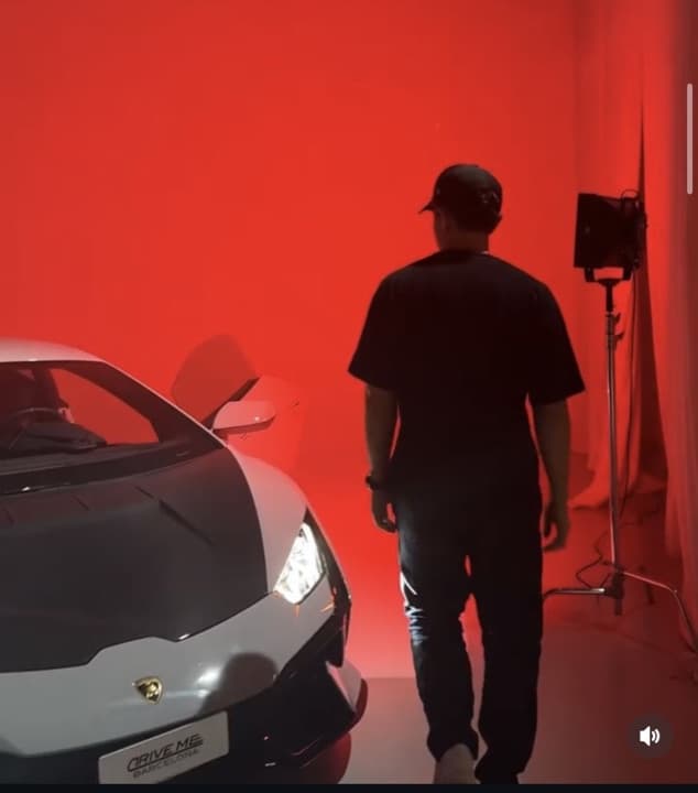 Behind the scenes of the supercar ad shoot, red studio light